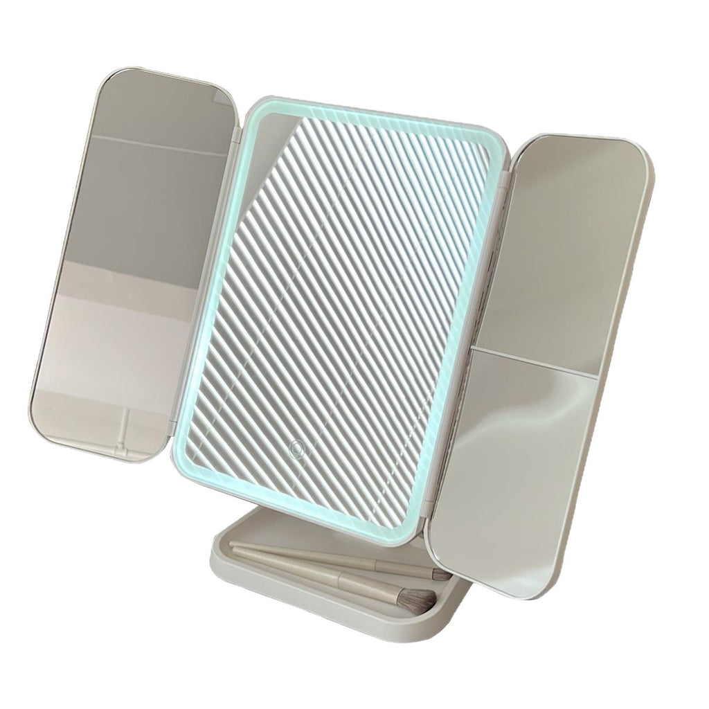 Foldable mirror with textured center and reflective sides on a white background