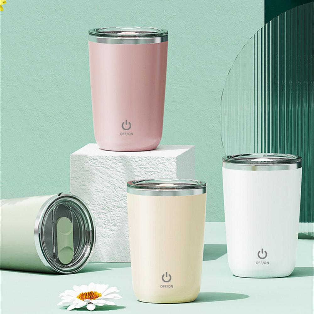 Set of four insulated tumblers in pink, cream, light green and white on a light green background.