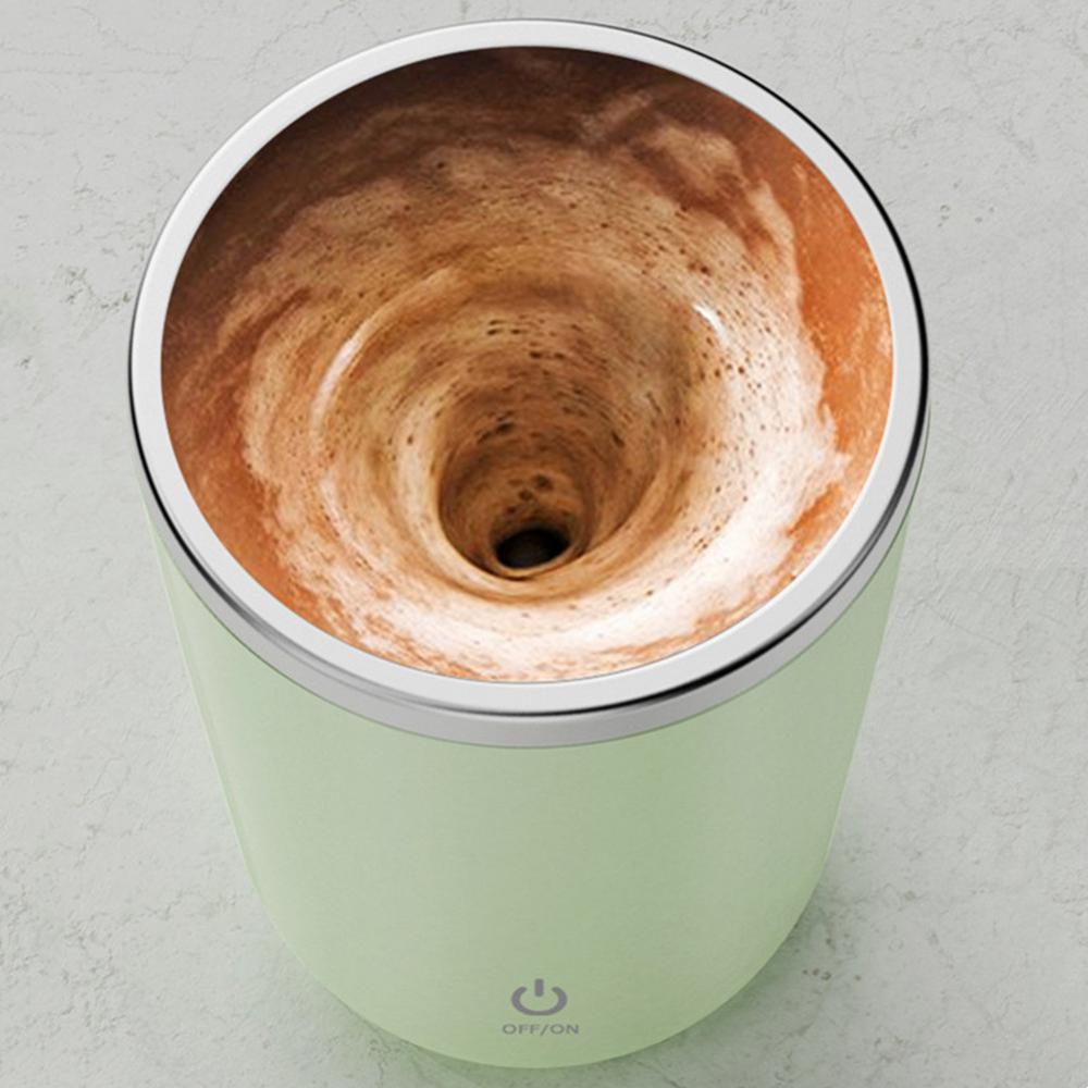 Light green coffee maker with a swirling brown liquid inside on a light gray background