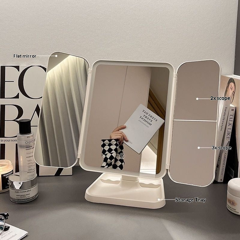 Foldable vanity mirror with different magnification levels on a table.