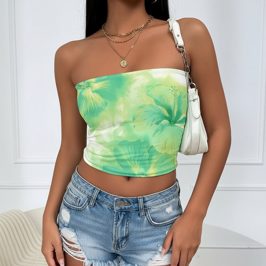 Green floral one-shoulder top worn by a person on a white background