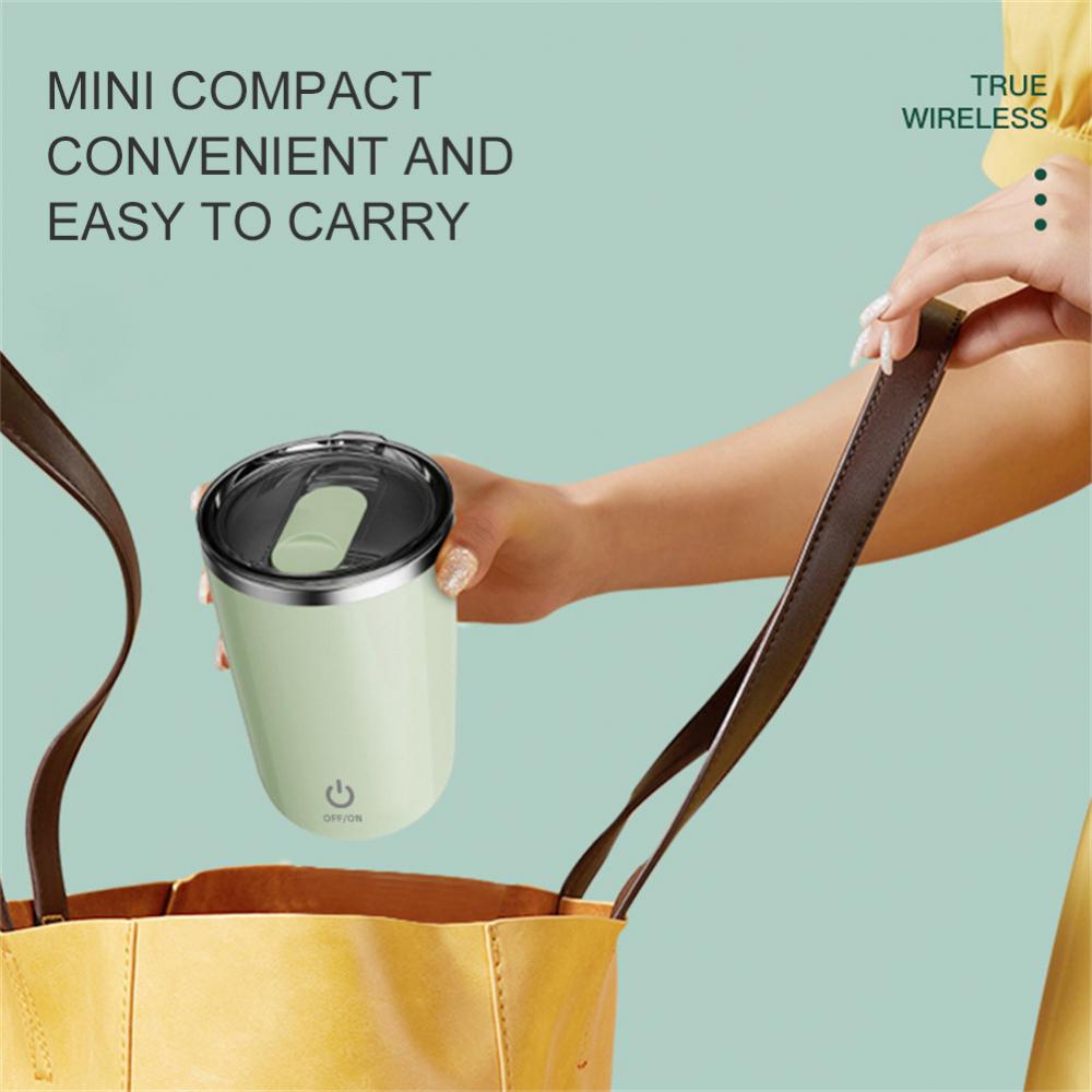 Person holding a light green travel mug with text about its compactness and ease of carrying.