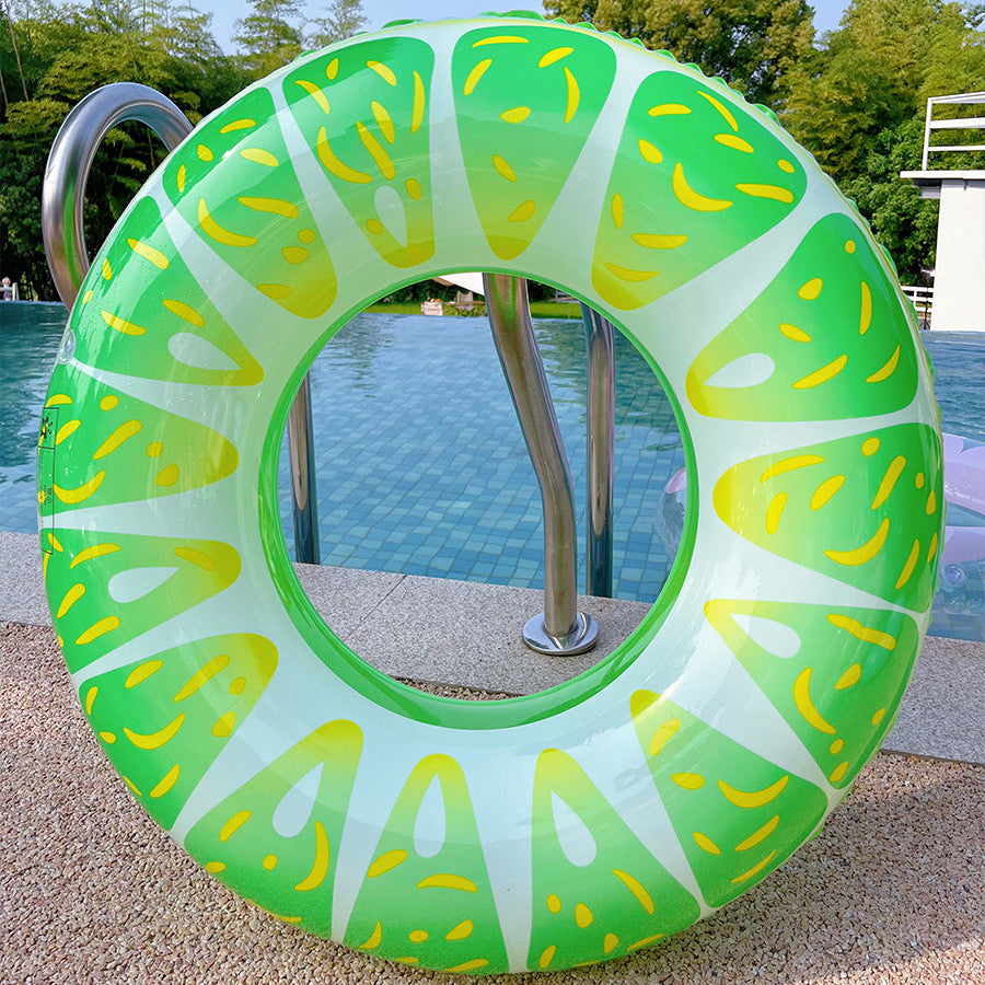 Green and yellow inflatable ring by a pool with trees in the background