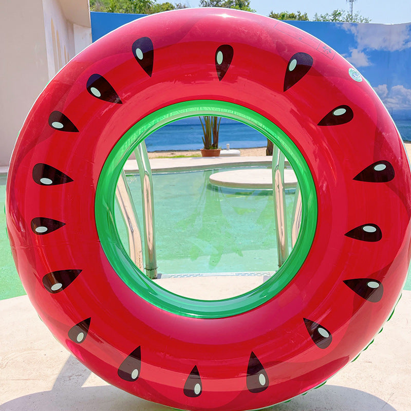 Inflatable pool toy shaped like a watermelon slice by a pool.
