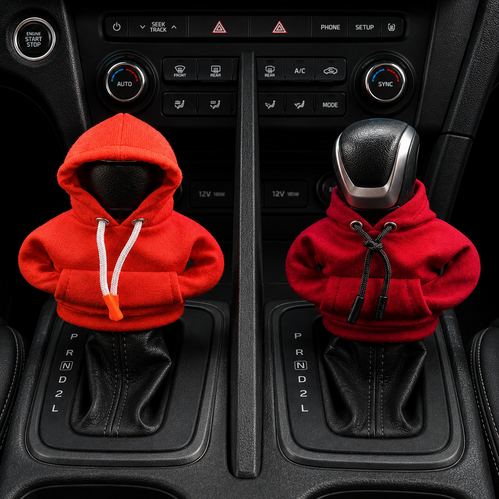 Car gear shift cover with orange red and red hoodies on a vehicle's control panel.