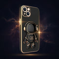 Black phone case with a gold astronaut charm on a dark background