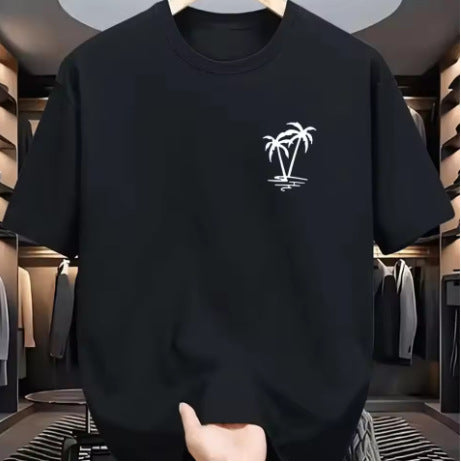 A black short-sleeve crewneck t-shirt with a small white palm tree graphic on the left chest, shown hanging in a clothing store.