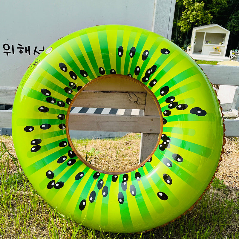 Green inflatable ring with black dot pattern on grass