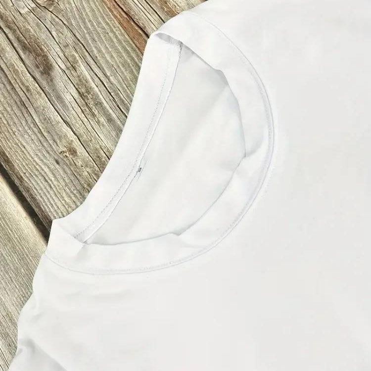 Close-up of a white women's cotton t-shirt on a wooden surface.